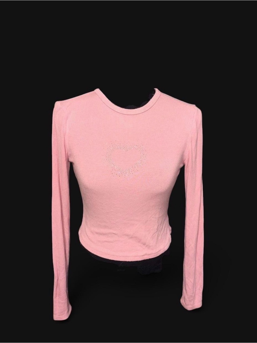Pink long sleeve crop top with heart-shaped rhinestone design